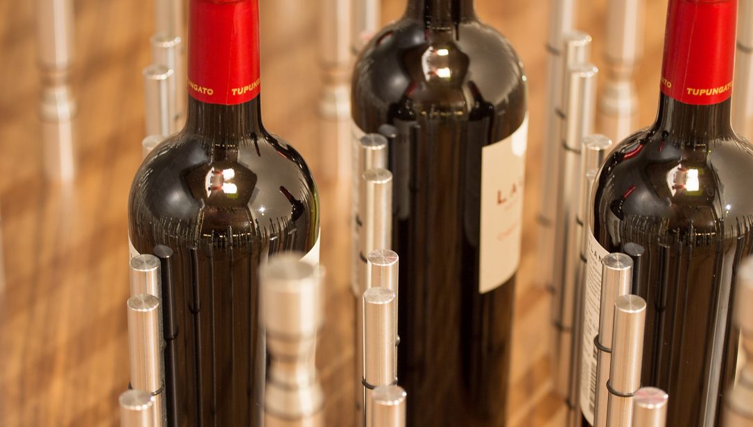 Three bottle of red wine store in a metal wine racking system