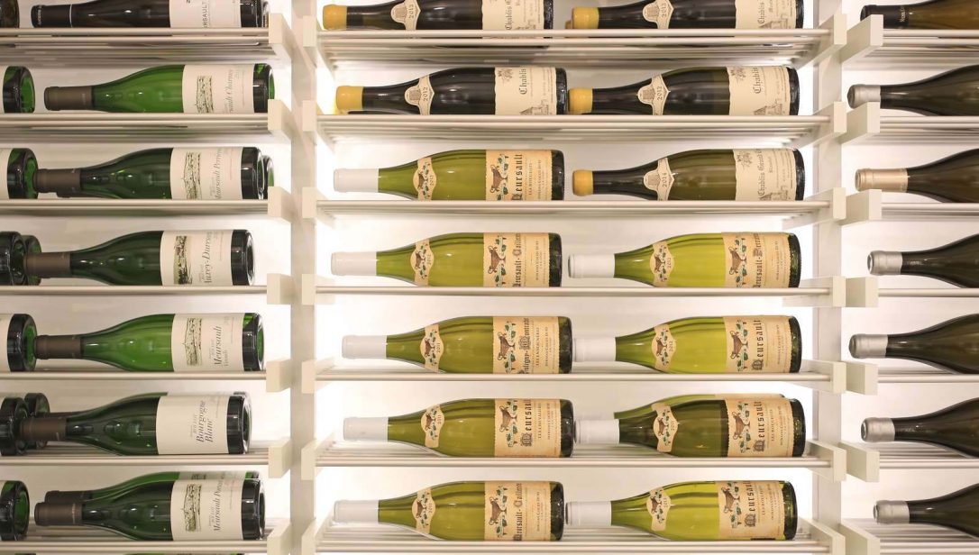 Metal wine rack mounted to wall in wine cellar