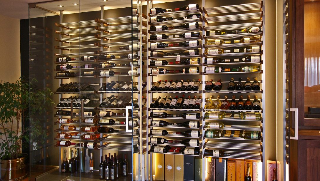Glass enclosed wine wall with metal racking