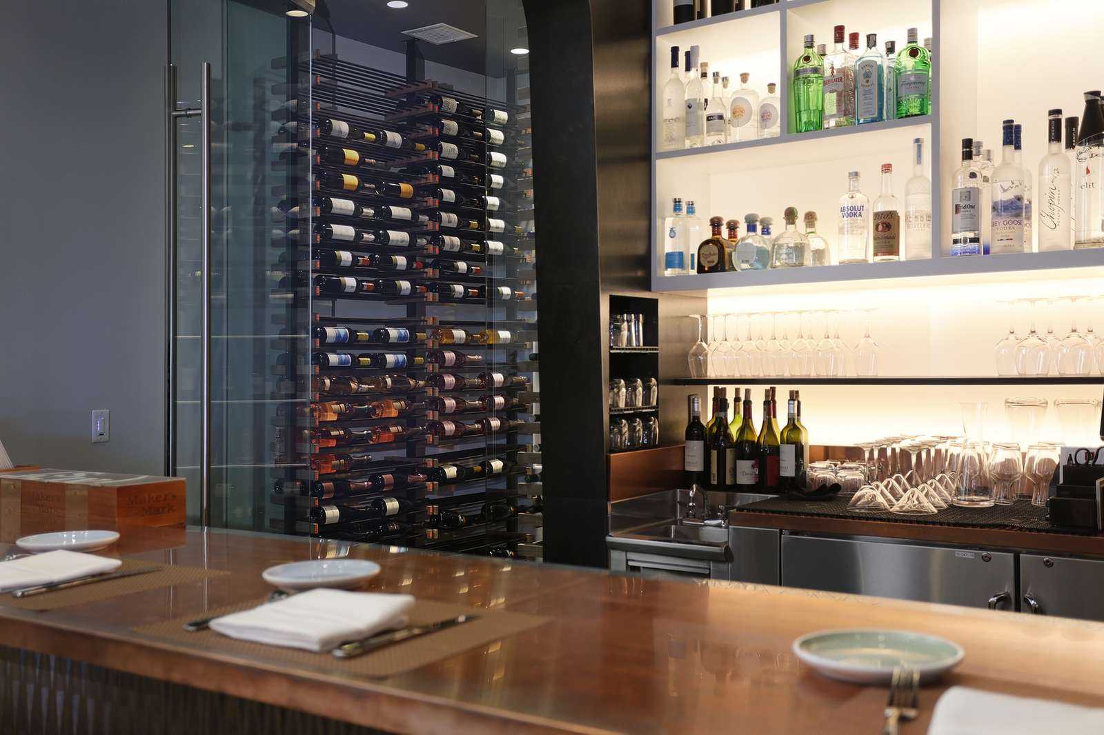 modern glass wine cellar behind bar